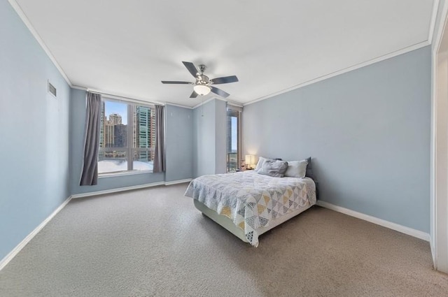 carpeted bedroom featuring crown molding, baseboards, and a ceiling fan