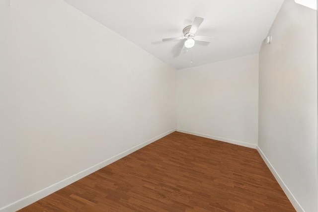 spare room featuring wood finished floors, baseboards, and a ceiling fan
