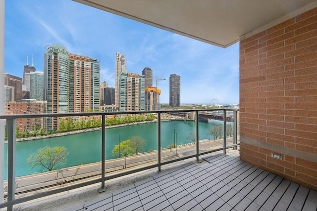 balcony featuring a water view and a view of skyline