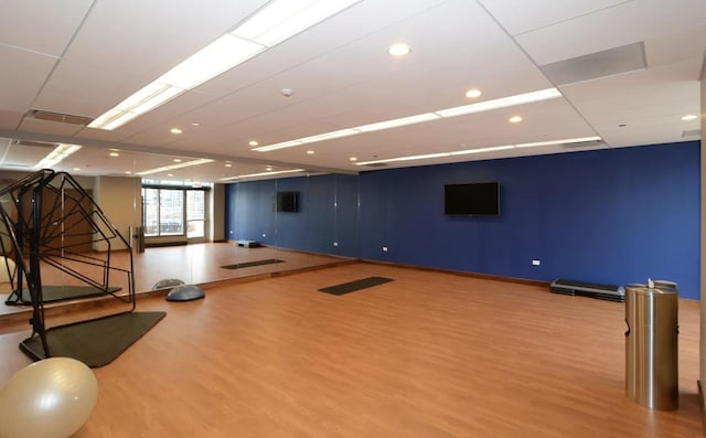 workout room featuring wood finished floors and recessed lighting