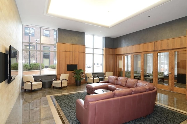 community lobby featuring a towering ceiling and floor to ceiling windows