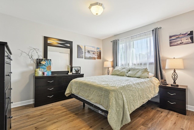 bedroom featuring baseboards and light wood finished floors