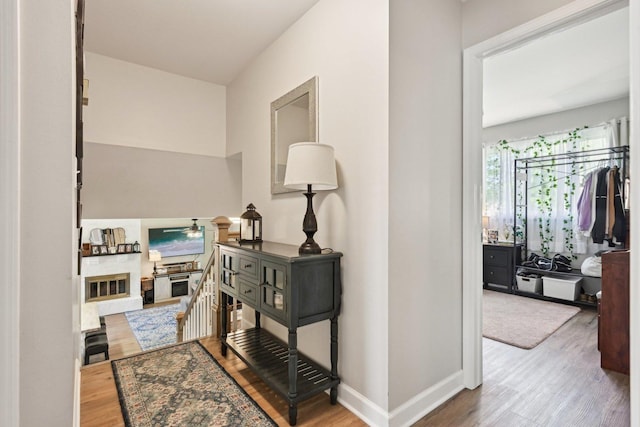 corridor featuring wood finished floors and baseboards