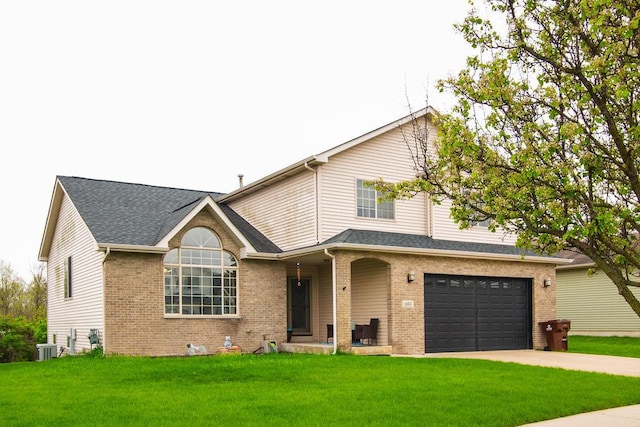 695 Cassandra Ln, University Park, IL 60466 - view of front facade featuring brick siding, a garage, driveway, and a front lawn