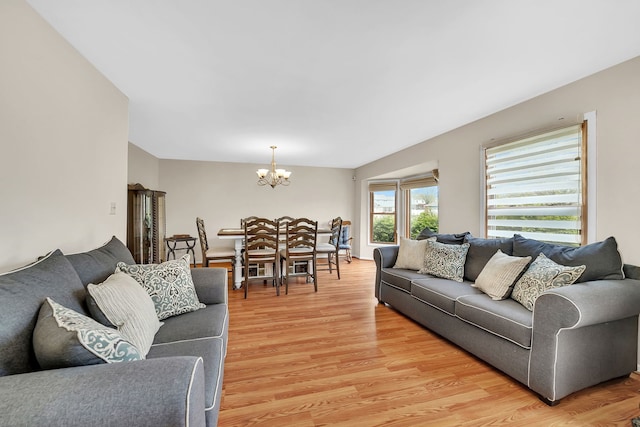 living area with light wood-type flooring and a chandelier