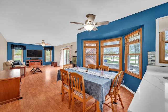 dining room with ceiling fan, plenty of natural light, and light wood-style floors
