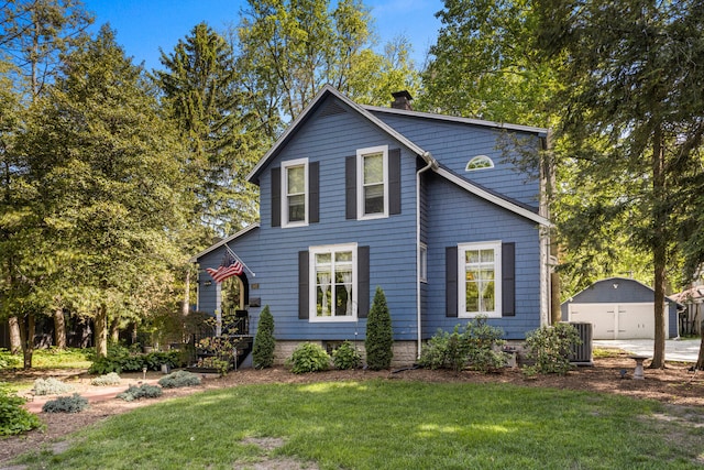 view of front of home featuring a chimney, a front yard, central AC, a garage, and an outdoor structure