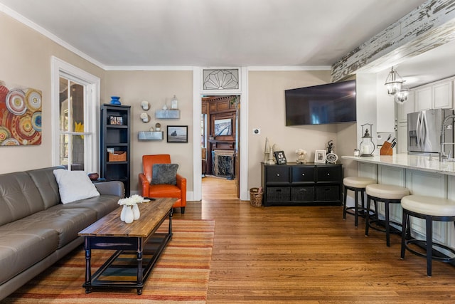living room featuring wood finished floors and ornamental molding