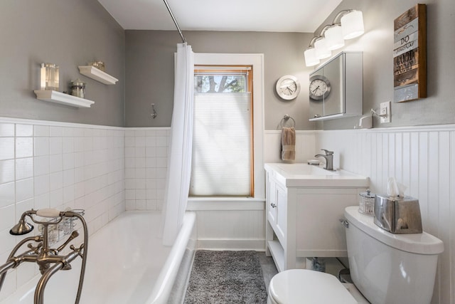full bathroom featuring wainscoting, toilet, a bathtub, vanity, and a shower with curtain