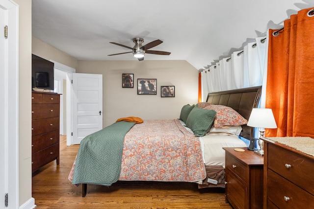 bedroom featuring wood finished floors, ceiling fan, and lofted ceiling