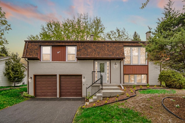 9 Shilling Ct, Bolingbrook, IL 60440 - bi-level home with a garage, a chimney, driveway, and brick siding
