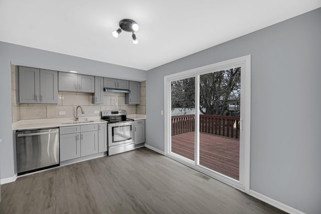 9 Shilling Ct, Bolingbrook, IL 60440 - kitchen with baseboards, light countertops, gray cabinets, a sink, and appliances with stainless steel finishes