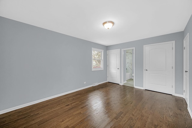 9 Shilling Ct, Bolingbrook, IL 60440 - unfurnished bedroom featuring baseboards, connected bathroom, and dark wood-style floors