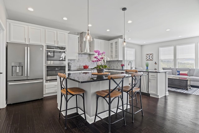 27025 Ashgate Xing, Plainfield, IL 60585 - kitchen featuring stainless steel appliances, a peninsula, dark countertops, backsplash, and white cabinets