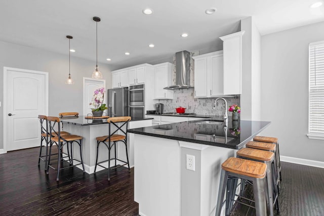 27025 Ashgate Xing, Plainfield, IL 60585 - kitchen with wall chimney exhaust hood, appliances with stainless steel finishes, a sink, a kitchen breakfast bar, and recessed lighting