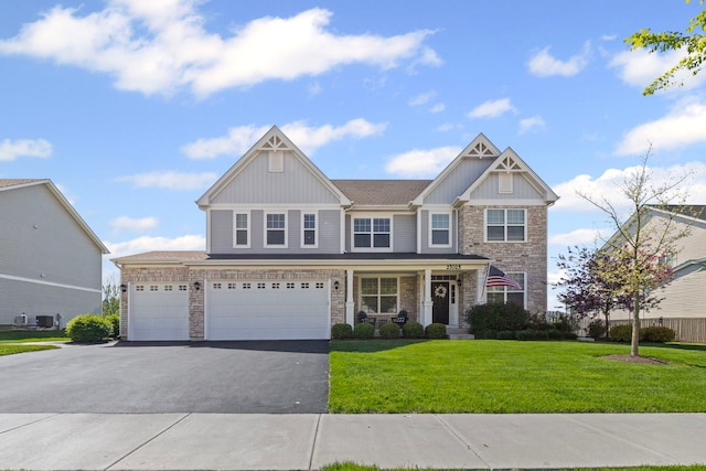 27025 Ashgate Xing, Plainfield, IL 60585 - craftsman inspired home featuring stone siding, asphalt driveway, a front lawn, board and batten siding, and a porch
