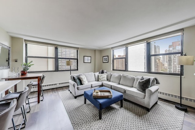 living room featuring wood finished floors, baseboard heating, and a baseboard heating unit