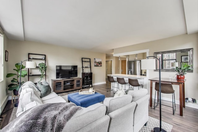 living area with light wood-style flooring and baseboards