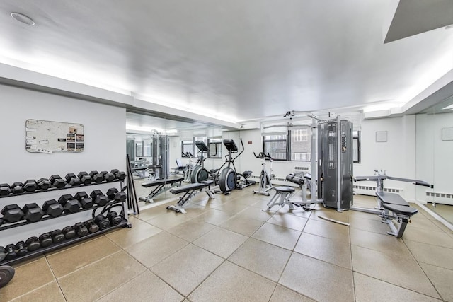 gym with a baseboard heating unit