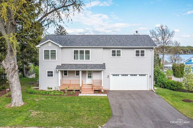 4520 W Shore Dr, Wonder Lake, IL 60097 - traditional home featuring a garage, covered porch, asphalt driveway, a front yard, and a shingled roof