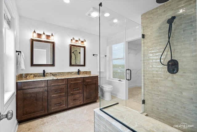 4520 W Shore Dr, Wonder Lake, IL 60097 - bathroom with a stall shower, double vanity, recessed lighting, and toilet