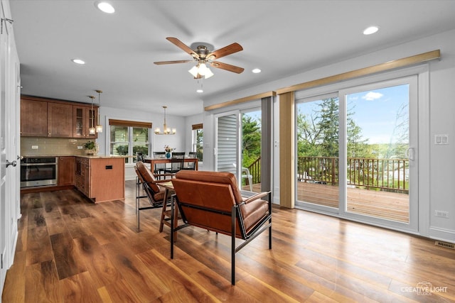 4520 W Shore Dr, Wonder Lake, IL 60097 - living room featuring dark wood-style flooring, ceiling fan, a chandelier, and recessed lighting