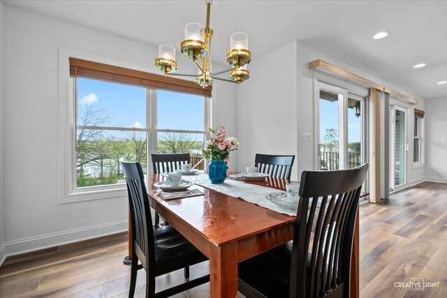 4520 W Shore Dr, Wonder Lake, IL 60097 - dining area featuring a chandelier, plenty of natural light, wood finished floors, baseboards, and recessed lighting