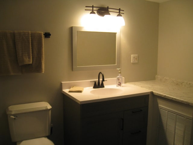 bathroom featuring toilet and vanity