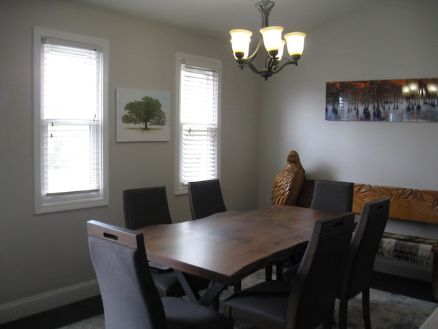 dining space with an inviting chandelier