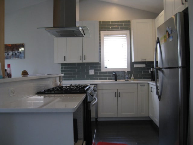 kitchen featuring a sink, lofted ceiling, island range hood, decorative backsplash, and appliances with stainless steel finishes