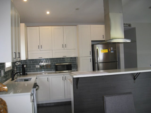 kitchen featuring a sink, stainless steel appliances, white cabinetry, and tasteful backsplash