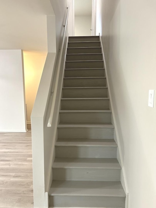 stairs with wood finished floors