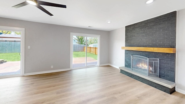 353 Marian Ct, Bolingbrook, IL 60440 - unfurnished living room with healthy amount of natural light, a brick fireplace, wood finished floors, and recessed lighting