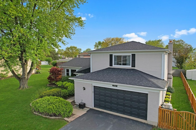 353 Marian Ct, Bolingbrook, IL 60440 - view of home's exterior featuring roof with shingles, a chimney, and asphalt driveway