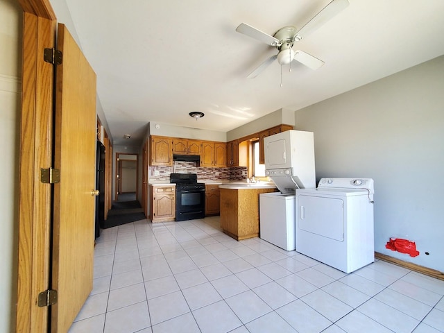 kitchen featuring a peninsula, black gas stove, light countertops, tasteful backsplash, and a ceiling fan
