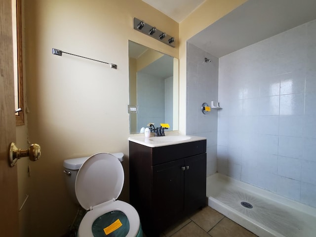 bathroom featuring vanity, tile patterned floors, a stall shower, and toilet