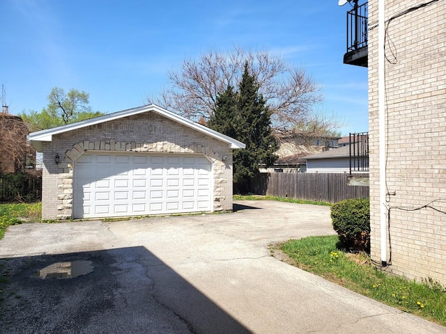 detached garage featuring fence