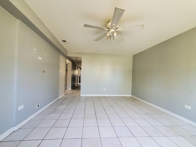 spare room with a ceiling fan, baseboards, visible vents, and light tile patterned flooring
