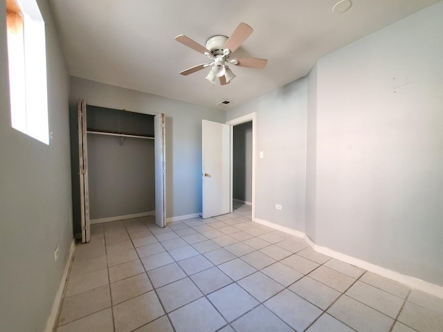 unfurnished bedroom with ceiling fan, visible vents, baseboards, a closet, and light tile patterned flooring