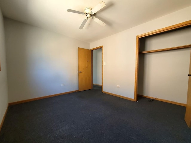unfurnished bedroom with baseboards, ceiling fan, a closet, and dark colored carpet