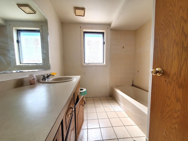 full bathroom with a bathing tub, plenty of natural light, tile patterned flooring, and vanity