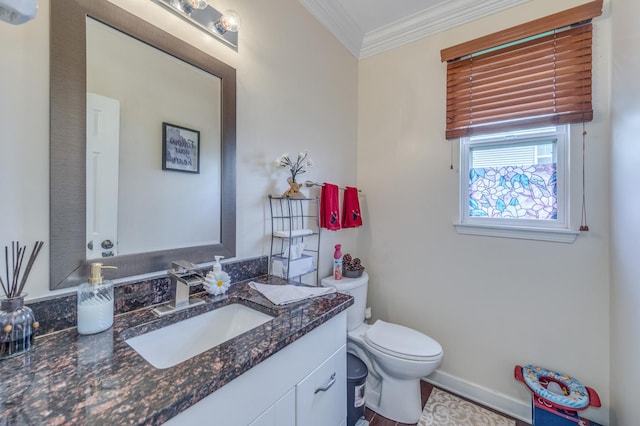 half bath with ornamental molding, toilet, baseboards, and vanity