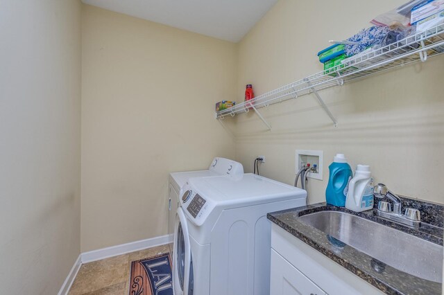 laundry area with washing machine and clothes dryer and baseboards