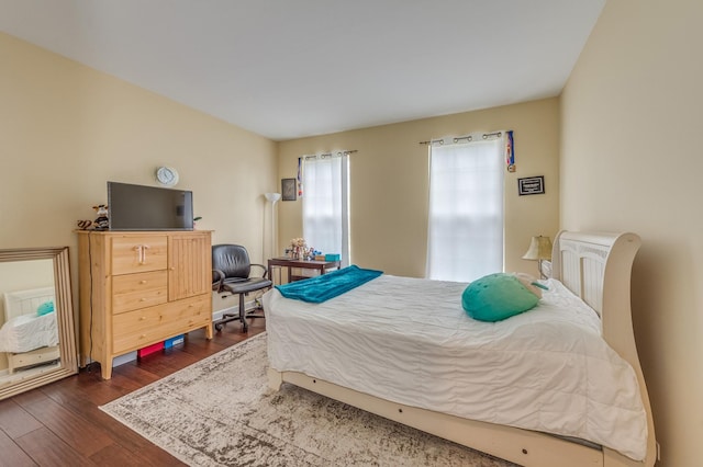 bedroom featuring dark wood finished floors