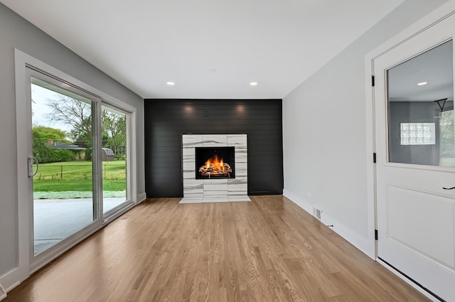 6340 Willow Springs Rd, La Grange Highlands, IL 60525 - unfurnished living room featuring light wood finished floors, recessed lighting, a fireplace with flush hearth, an accent wall, and baseboards
