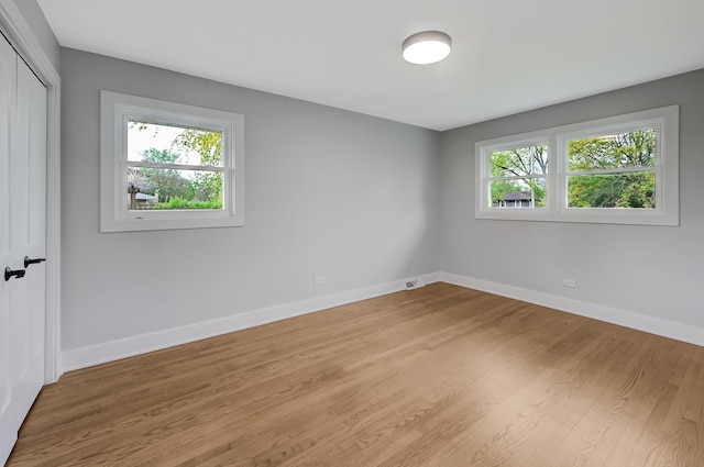 6340 Willow Springs Rd, La Grange Highlands, IL 60525 - unfurnished bedroom with a closet, baseboards, and light wood-style floors