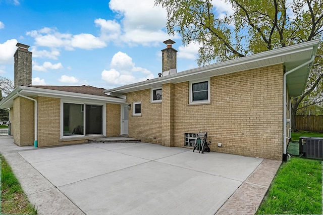 6340 Willow Springs Rd, La Grange Highlands, IL 60525 - rear view of house featuring a chimney, a patio area, central AC unit, and brick siding