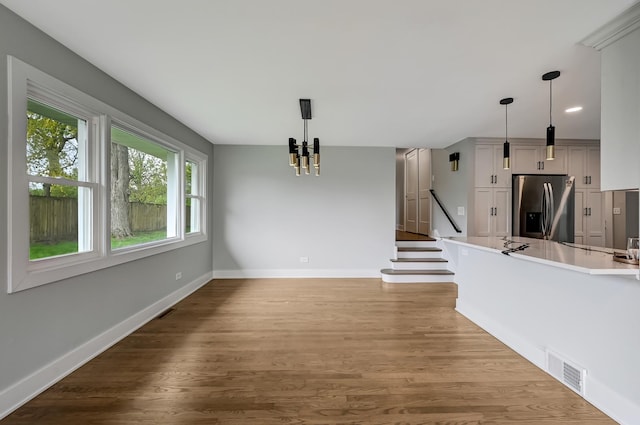 6340 Willow Springs Rd, La Grange Highlands, IL 60525 - unfurnished living room with a chandelier, wood finished floors, baseboards, stairway, and recessed lighting