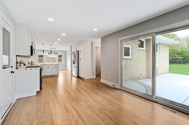 6340 Willow Springs Rd, La Grange Highlands, IL 60525 - kitchen featuring stainless steel refrigerator, gas stove, white cabinets, light wood-style flooring, and recessed lighting