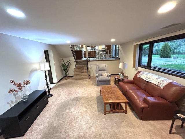 living room featuring stairs, visible vents, recessed lighting, and carpet